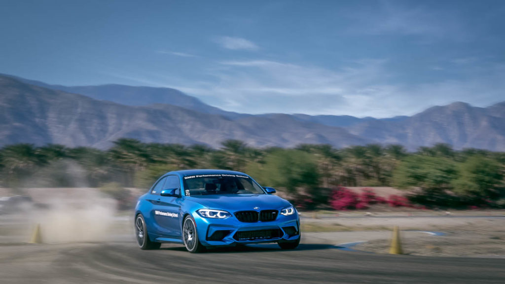 blue BMW M240i on BMW Performance Driving School race track going fast